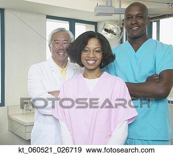 Stock Photograph - senior asian male 
dentist with african 
male and female 
dental. fotosearch 
- search stock 
photos, pictures, 
images, and photo 
clipart