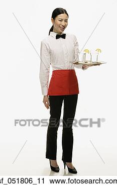 Stock Photography - studio shot of 
asian waitress 
holding tray of 
drinks. fotosearch 
- search stock 
photos, pictures, 
images, and photo 
clipart