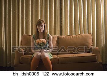 Stock Photo - woman sitting 
on sofa with bouquet 
of flowers. fotosearch 
- search stock 
photos, pictures, 
images, and photo 
clipart