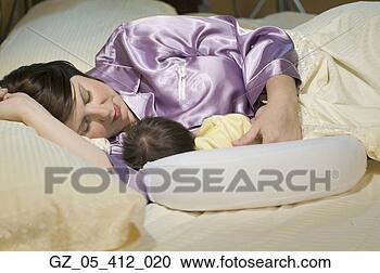 Stock Photography - woman sleeping 
with newborn baby. 
fotosearch - search 
stock photos, 
pictures, images, 
and photo clipart