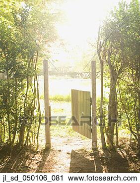 Stock Photography - wooden gate open 
to sunlit field. 
fotosearch - search 
stock photos, 
pictures, images, 
and photo clipart