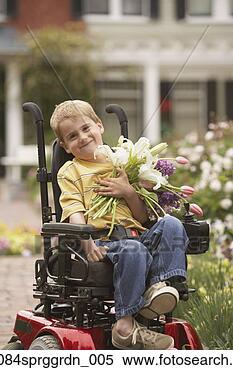 Stock Image - young boy in wheelchair 
with flowers outdoors. 
fotosearch - search 
stock photos, 
pictures, images, 
and photo clipart