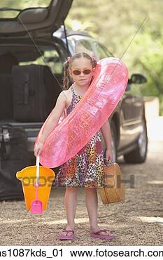 Stock Photography - young girl in 
flip flops with 
beach toys. fotosearch 
- search stock 
photos, pictures, 
images, and photo 
clipart