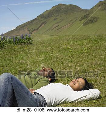 Stock Photo - african couple 
laying in sunlit 
grass with eyes 
closed in rural 
area. fotosearch 
- search stock 
photos, pictures, 
images, and photo 
clipart