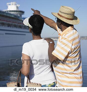 Stock Photo - african couple 
pointing at cruise 
ship. fotosearch 
- search stock 
photos, pictures, 
images, and photo 
clipart