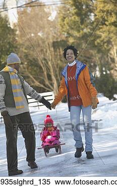 Stock Image - african couple 
pulling child 
on sled. fotosearch 
- search stock 
photos, pictures, 
images, and photo 
clipart