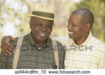 Stock Photo - african father 
and adult son 
smiling outdoors. 
fotosearch - search 
stock photos, 
pictures, images, 
and photo clipart