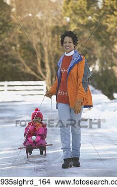 Stock Photo - african mother 
pulling child 
on sled. fotosearch 
- search stock 
photos, pictures, 
images, and photo 
clipart