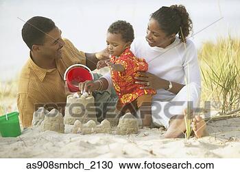 Stock Photography - african parents 
and toddler building 
sand castle at 
beach. fotosearch 
- search stock 
photos, pictures, 
images, and photo 
clipart
