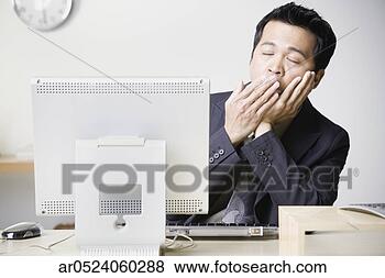 Stock Photo - asian businessman 
sitting at computer 
yawning. fotosearch 
- search stock 
photos, pictures, 
images, and photo 
clipart