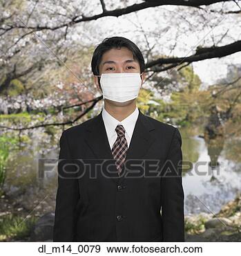 Stock Photograph - asian businessman 
wearing surgical 
mask in park. 
fotosearch - search 
stock photos, 
pictures, images, 
and photo clipart