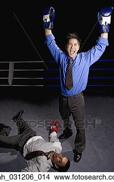 Stock Photo - businessman in 
boxing ring cheering 
over opponent 
on floor. fotosearch 
- search stock 
photos, pictures, 
images, and photo 
clipart