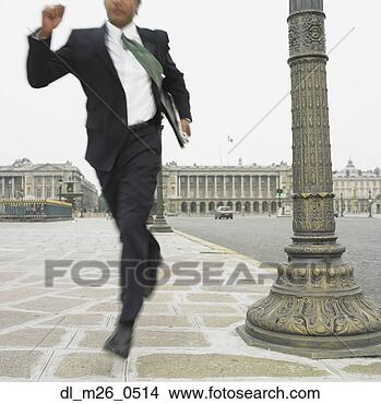 Stock Photo - businessman running 
in historical 
city square. fotosearch 
- search stock 
photos, pictures, 
images, and photo 
clipart