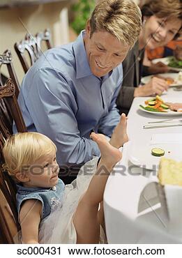 Stock Photography - father smiling 
at toddler with 
feet on dinner 
table. fotosearch 
- search stock 
photos, pictures, 
images, and photo 
clipart