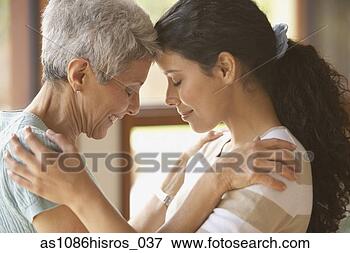 Picture - hispanic mother 
and adult daughter 
touching foreheads. 
fotosearch - search 
stock photos, 
pictures, images, 
and photo clipart