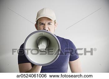 Stock Photo - man wearing baseball 
hat and yelling 
into megaphone. 
fotosearch - search 
stock photos, 
pictures, images, 
and photo clipart