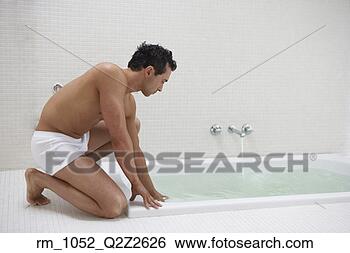 Stock Photo - man wearing underwear 
with hand in bath 
water. fotosearch 
- search stock 
photos, pictures, 
images, and photo 
clipart