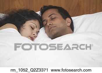 Stock Photography - middle eastern 
couple sleeping 
in bed. fotosearch 
- search stock 
photos, pictures, 
images, and photo 
clipart