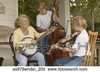 Stock Image - mother and sons 
playing instruments 
together on porch. 
fotosearch - search 
stock photos, 
pictures, images, 
and photo clipart