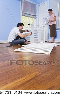 Stock Photo - pregnant couple 
putting crib together. 
fotosearch - search 
stock photos, 
pictures, images, 
and photo clipart