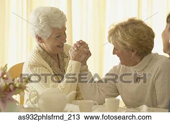 Stock Photo - two senior women 
arm wrestling. 
fotosearch - search 
stock photos, 
pictures, images, 
and photo clipart