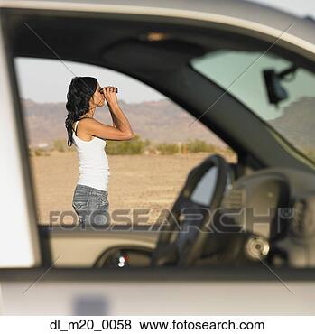 Stock Photo - view through car 
windows at woman 
using binoculars 
outdoors. fotosearch 
- search stock 
photos, pictures, 
images, and photo 
clipart