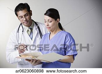 Stock Photo - hispanic male 
doctor and hispanic 
female nurse looking 
at file. fotosearch 
- search stock 
photos, pictures, 
images, and photo 
clipart