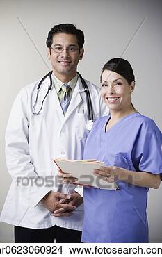 Stock Photo - hispanic male 
doctor and hispanic 
female nurse smiling. 
fotosearch - search 
stock photos, 
pictures, images, 
and photo clipart