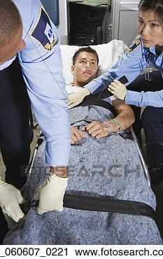 Stock Photography - man in ambulance 
with paramedics. 
fotosearch - search 
stock photos, 
pictures, images, 
and photo clipart