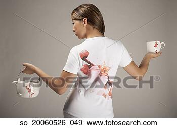 Stock Photograph - rear view of woman 
holding teapot 
and teacup. fotosearch 
- search stock 
photos, pictures, 
images, and photo 
clipart