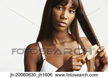 Stock Photo - studio shot of 
african woman 
wearing bra and 
brushing hair. 
fotosearch - search 
stock photos, 
pictures, images, 
and photo clipart