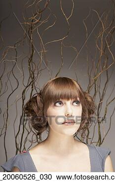 Stock Photography - woman with hair 
up and branches 
in background. 
fotosearch - search 
stock photos, 
pictures, images, 
and photo clipart