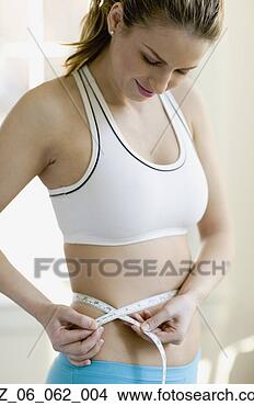 Stock Photo - woman measuring 
waist with tape 
measure. fotosearch 
- search stock 
photos, pictures, 
images, and photo 
clipart