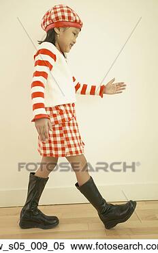 Stock Image - young asian girl 
walking indoors. 
fotosearch - search 
stock photos, 
pictures, images, 
and photo clipart