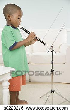Stock Photo - african boy playing 
a recorder with 
sheet music. fotosearch 
- search stock 
photos, pictures, 
images, and photo 
clipart