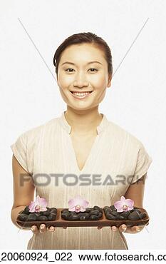 Stock Photo - asian woman holding 
spa treatment 
tray. fotosearch 
- search stock 
photos, pictures, 
images, and photo 
clipart