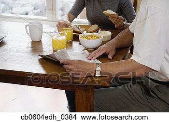 Stock Photo - couple eating 
breakfast and 
reading newspaper. 
fotosearch - search 
stock photos, 
pictures, images, 
and photo clipart