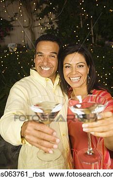 Stock Photo - hispanic couple 
toasting with 
cocktails at night. 
fotosearch - search 
stock photos, 
pictures, images, 
and photo clipart