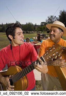 Stock Photo - hispanic father 
and adult son 
playing instruments 
at party. fotosearch 
- search stock 
photos, pictures, 
images, and photo 
clipart