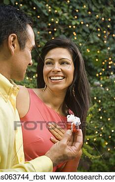 Stock Photo - hispanic man giving 
wife gift outdoors. 
fotosearch - search 
stock photos, 
pictures, images, 
and photo clipart