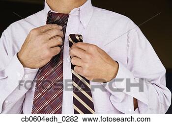 Stock Photo - man comparing 
neckties. fotosearch 
- search stock 
photos, pictures, 
images, and photo 
clipart