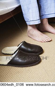 Stock Photo - man's bare feet 
next to slippers. 
fotosearch - search 
stock photos, 
pictures, images, 
and photo clipart