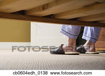 Stock Photo - man's feet in 
slippers next 
to bed. fotosearch 
- search stock 
photos, pictures, 
images, and photo 
clipart