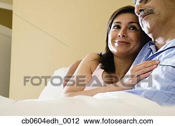 Stock Photo - middle-aged couple 
hugging in bed. 
fotosearch - search 
stock photos, 
pictures, images, 
and photo clipart
