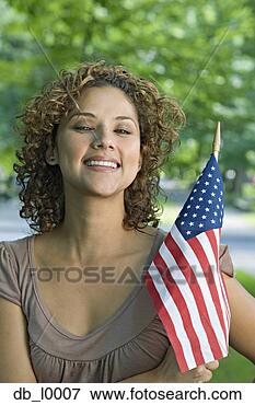 Picture - portrait of hispanic 
woman holding 
american flag. 
fotosearch - search 
stock photos, 
pictures, images, 
and photo clipart