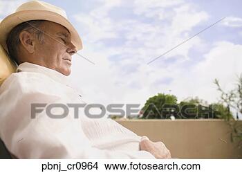 Stock Photo - senior man sleeping 
in chair outdoors. 
fotosearch - search 
stock photos, 
pictures, images, 
and photo clipart