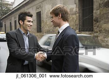 Stock Photography - two hispanic businessmen 
shaking hands 
in street. fotosearch 
- search stock 
photos, pictures, 
images, and photo 
clipart
