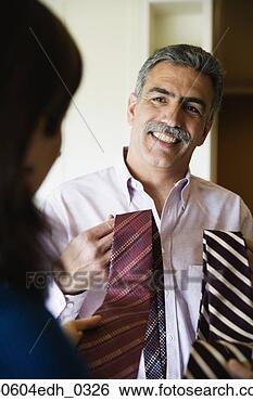 Stock Photo - woman helping 
husband choose 
necktie. fotosearch 
- search stock 
photos, pictures, 
images, and photo 
clipart