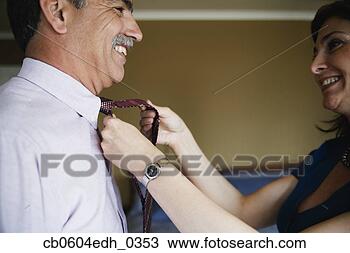 Stock Photo - woman helping 
husband tie necktie. 
fotosearch - search 
stock photos, 
pictures, images, 
and photo clipart