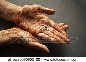 Stock Photography - woman holding 
ring in henna 
tattooed hands. 
fotosearch - search 
stock photos, 
pictures, images, 
and photo clipart